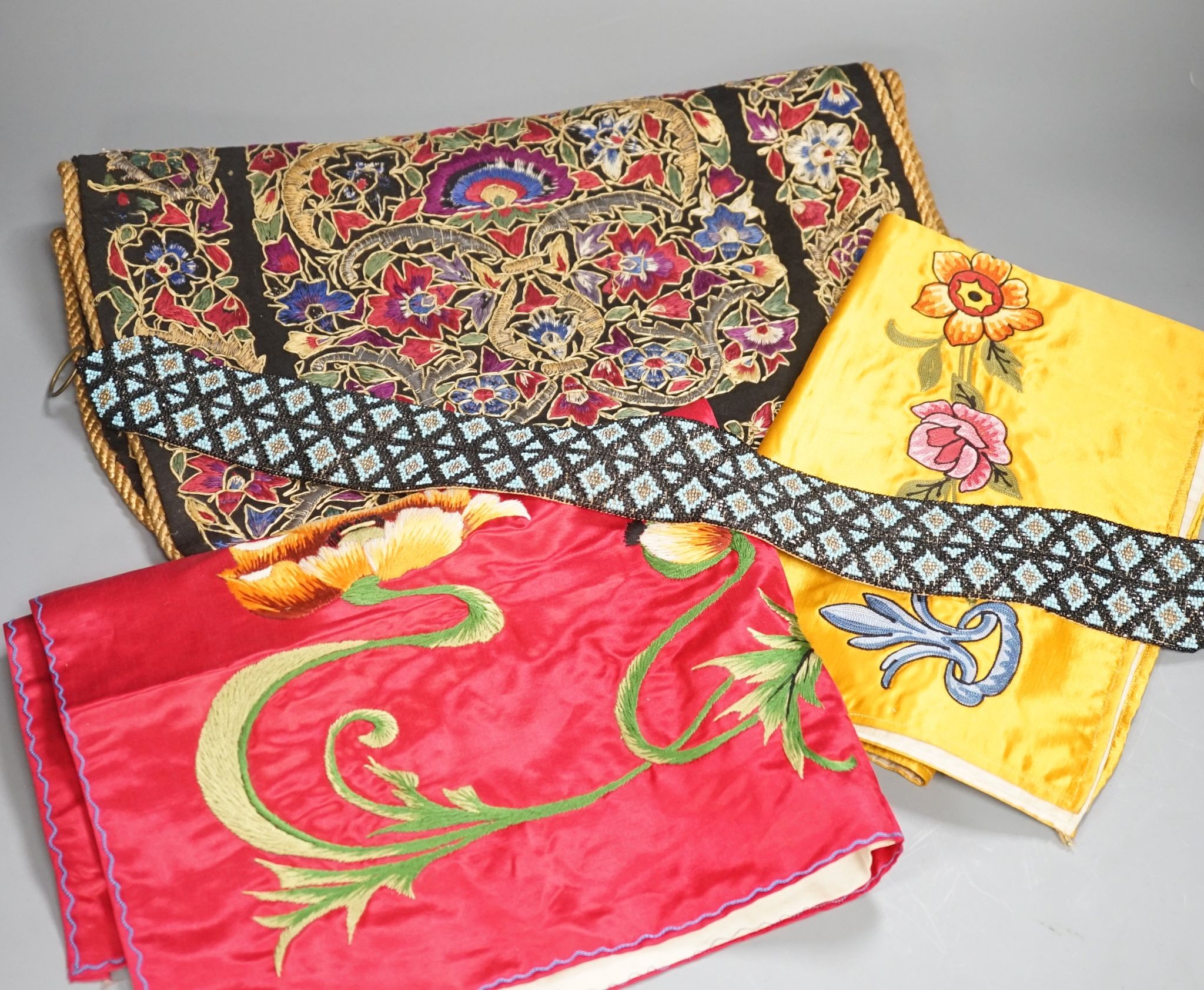 A Berlin beadwork panel , another, a beaded cushion, a book and embroidered banners, 2 silk panels etc